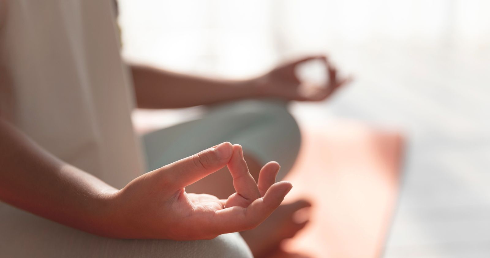 A close-up yoga mudra in soft natural light