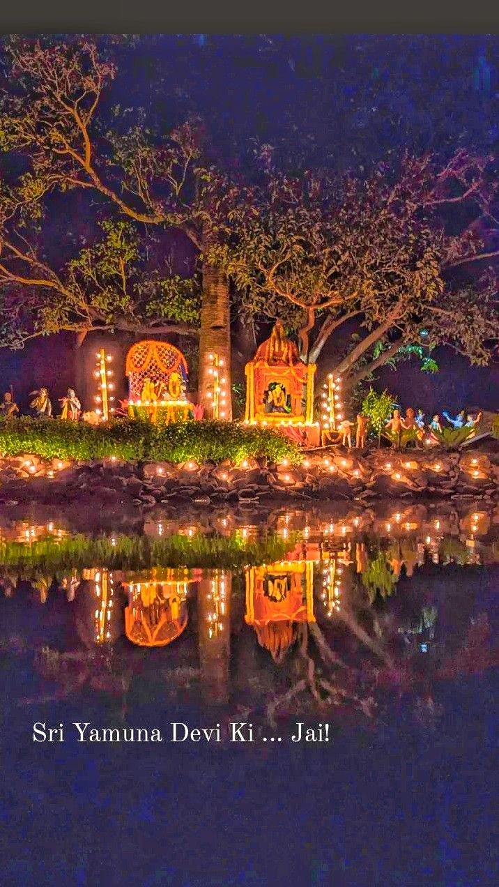 Illuminated shrines reflected in the water at Gupta Yamuna
